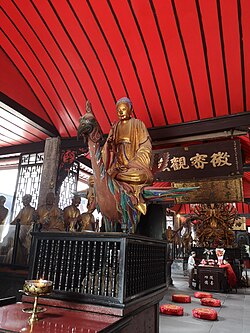 Statue of Amituofo (Amitābha) riding on a peacock at the centre and the Thousand-armed Guanyin at the rear of the Five Hundred Arhat Hall of Baoguang Temple in Chengdu, Sichuan province, China