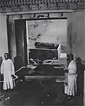 State of the burial chamber of the Empress Dowager Cixi's tomb, photographed as part of the post-1928 looting investigations. Her discarded corpse, burial shroud and damaged coffin are visible in the background.