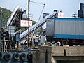 Loading blocks of factory-made ice from a truck to an "ice depot" boat