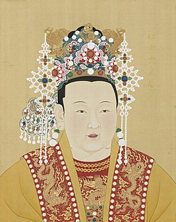 Empress Xu wears red and yellow robes and a crown decorated with pearls and gold dragons and phoenixes