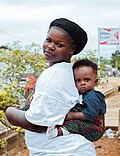 Photo of a woman carrying a child