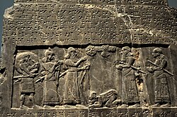The Black Obelisk of Shalmaneser III. The king, surrounded by his royal attendants and a high-ranking official, receives a tribute from Sua, king of Gilzanu (north-west Iran), who bows and prostrates before the king. From Nimrud, northern Mesopotamia (Iraq). Neo-Assyrian period, 825 BC. The British Museum, London.