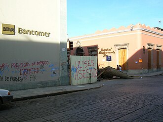 Street barricade with graffiti and debris in central Oaxaca