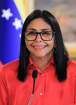 Photograph of Rodríguez at the age of 56 being dressed in a pink suit and shirt.