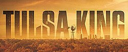 A large wooded area with a windmill in the foreground and a cityscape in the background. Text above the city reads "Tulsa King".