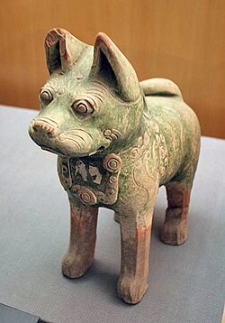 A dog figurine found in a Han tomb wearing a decorative dog collar, indicating their domestication as pets.[184] Dog figurines are a common archaeological find in Han tombs,[185] while it is also known from written sources that the emperor's imperial parks had kennels for keeping hunting dogs.[186]