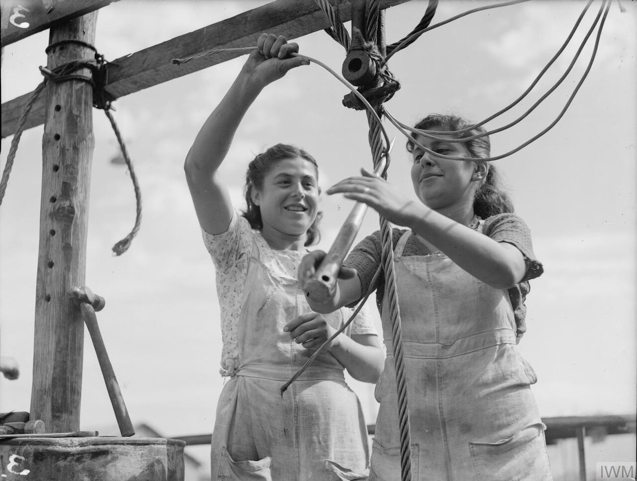 ALLIED WOMEN REPAIR NAVAL GEAR IN MEDITERRANEAN PORT. 6 AND 7 OCTOBER 1943, BEIRUT. SOME 150 GIRLS OF LEBANESE, ARMENIAN, GREEK, AND OTHER NATIONALITIES ARE WORKING FULL TIME FOR THE ROYAL NAVY. CLEANING AND PA A20008.jpg