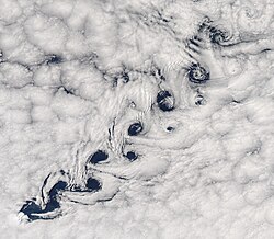 An example of a Kármán vortex street, an emergent phenomenon from Fluid dynamics.