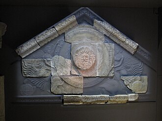 A Partially restored Pediment featuring a Gorgon Head