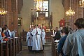 Evangelical-Lutheran acolytes (with the crossbearer in the center) prepare for the Gospel Reading during High Mass at Holy Trinity Church in Uppsala on the Feast Day of the Apostles Philip and James the Less