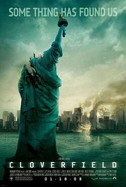 A decapitated Statue of Liberty is in front of a partially wrecked New York City.