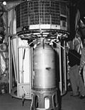 TIROS-2 satellite atop of launch vehicle, under hangar roof