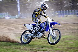 Motion blur is frequently employed in sports photography (particularly motorsports) to convey a sense of speed. To achieve this effect it is necessary to use a slow shutter speed and pan the lens of the camera in time with the motion of the object.