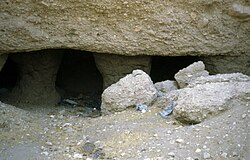 Portico of the tomb, columns half buried in the sand