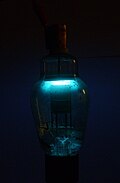 Westinghouse 866A mercury vapor half-wave rectifier tube. Glowing with 5mA in the dark (long exposure)
