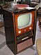 old television in tall wood cabinet