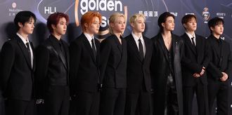 The eight members of Stray Kids, looking forward.