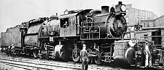 The Wootten firebox can be seen as the large construction just in front of the tender. Note the unusual position of the driver's cab. The fireman was left exposed between firebox and tender.