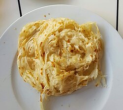 A light-coloured flatbread that is round and layered.