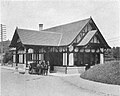 old black-and-white photo of small building with horse and carriage drawn up
