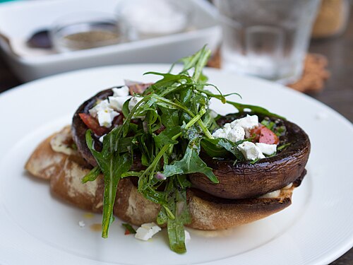 Grilled portobello, feta, and arugula (rocket) salad on a toasted baguette