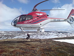 A Eurocopter EC-120 helicopter – the rotor blades seem to be swept back more than usual due to the rolling-shutter effect.
