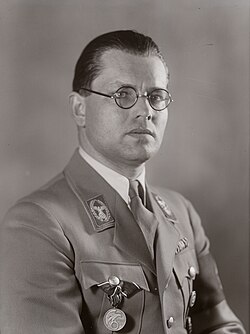 Black-and-white head shot of Bouhler wearing uniform of the Nazi Party