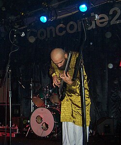 Babar Luck onstage at Concorde 2 whilst playing with King Prawn, 2002
