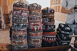 Doppas for sale in Bukhara, Uzbekistan. The first and second stacks are Shahrisabz doppas, the three on the top of the third stack are Surxon doppas, and the last stack are Chust doppas.