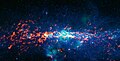 Sagittarius B2 is seen here the right orange-red region to the middle left of the image. Image by ATLASGAL (red) and MSX (blue, green).