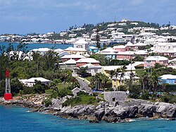 Residential suburb near the old St. George's Garrison, with "Town Cut Battery" or "Gate's Fort" on the shore of the Town Cut, and St. George's Town and its harbour in the background